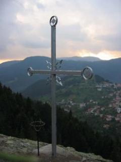 A cross on a cliff impresses visitors of the village Momchilovtsi